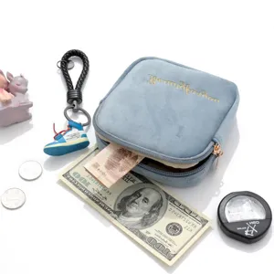 Blue velvet storage pouch with cute sneaker keychain, portable cosmetic and sanitary bag