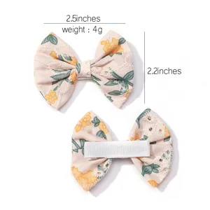 Detailed view of children's floral embroidered bow hair clip with size dimensions