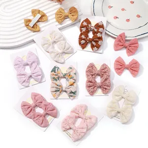 Variety pack of embroidered floral fabric bow hair clips for girls' hair accessories.