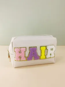 Detail shot of the large capacity PU makeup bag featuring colorful chenille patch letters.