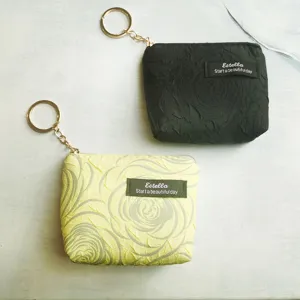 Mini coin purse with keychain and zipper, cute floral crinkle design, portable card key bag.