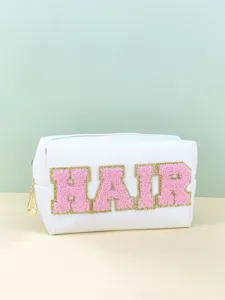 White PU cosmetic bag detail featuring pink chenille letter patch HAIR with gold glitter trim.