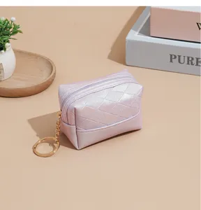 Close-up detail of the pearl gradient quilted coin purse with keychain and zipper closure.