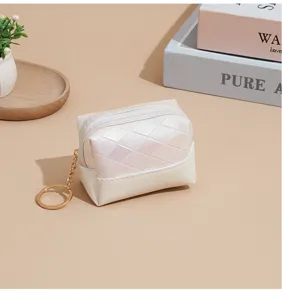 Small white iridescent quilted coin purse with keychain, PU leather lipstick pouch detail.