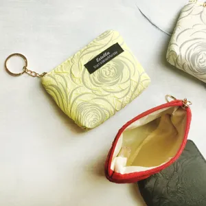 Mini zipper coin purse with keychain and cute rose texture, compact wallet for daily use.