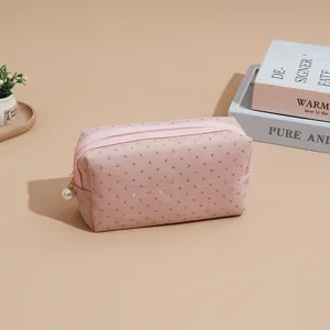 Pink corduroy cosmetic bag with gold glitter dots and a pearl zipper pull for daily use.