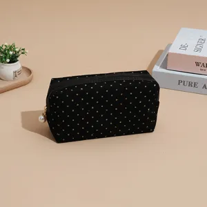 Black corduroy cosmetic bag with gold glitter dots and pearl zipper pull for daily travel.