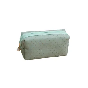 Mint green corduroy cosmetic bag with gold glitter dots and cute pearl zipper pull for daily use.