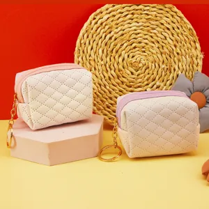 Mini quilted coin purse with zipper and keychain, cute portable storage pouch for daily use.