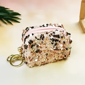 Detailed view of the pink sequin mini coin purse, trendy lipstick and coin storage bag.