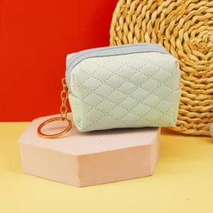 Mini quilted coin purse with zipper closure and cute gold keychain for daily storage and keys.