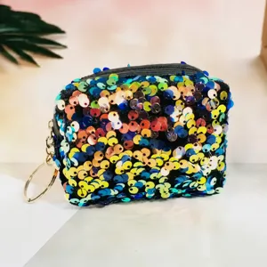 Detail view of colorful sequin mini coin purse, trendy lipstick and daily small items storage.