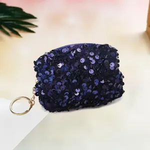 Dark blue sequin mini coin purse with keychain ring, compact lipstick storage pouch detail.