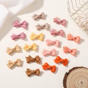 Close-up detail of multi-color grosgrain ribbon bow hair clips for kids and babies