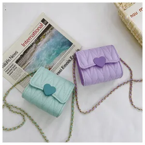 Quilted mini heart crossbody bag for kids with metal chain strap in mint green and lavender.