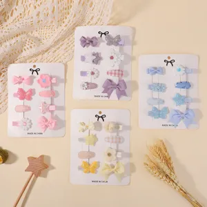 Detail view of colorful baby hair clip sets featuring bows and floral designs