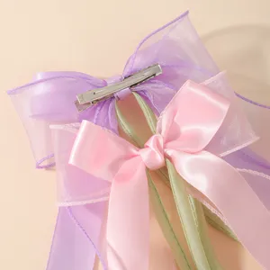 Detail view of the back metal clip and layered organza ribbon on tulip bow hair clips