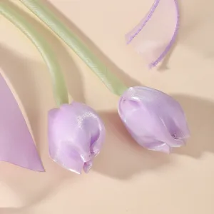 Detailed macro view of purple satin tulip flowers on a high-end children's hair accessory