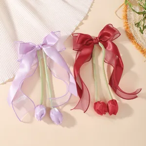 Elegant children's tulip bow hair clips with long streamers in purple and red.