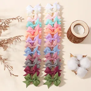 Macro detail of various colorful grosgrain ribbon bow hair clips set for babies and kids
