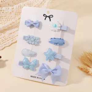 Close-up detail of 8pcs light blue baby hair clip set with cute bows stars and flowers.