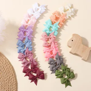 Detailed view of colorful grosgrain ribbon bow hair clips in various bright colors