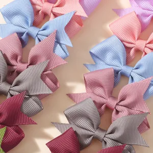 Close-up macro view of colorful grosgrain ribbon bow hair clips for babies and girls