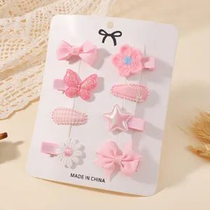 Detail view of 8-piece pink baby hair clip set with butterfly and bow on display card