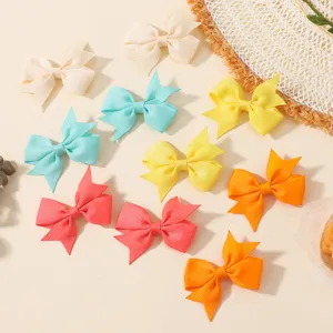 Close-up of colorful handmade grosgrain ribbon hair bows in assorted pastel shades