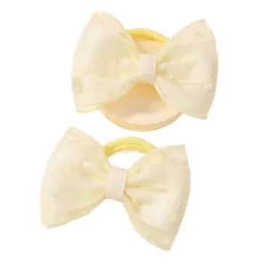Pair of delicate yellow mesh bow hair ties for children with cute heart patterns