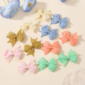 Detailed view of handmade colorful grosgrain ribbon hair bows in various pastel colors.