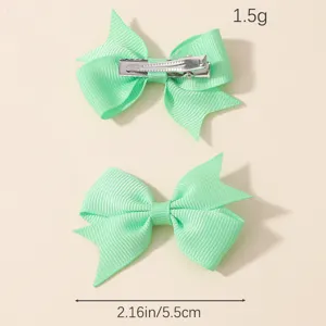 Detailed view of mint green grosgrain ribbon bow hair clips with 5.5cm size dimensions