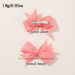 Pair of cute pink ribbed ribbon bow hair clips for kids with dimensions and weight