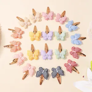 Colorful plaid butterfly hair clips detail showing various cute patterns and pearl decorations.
