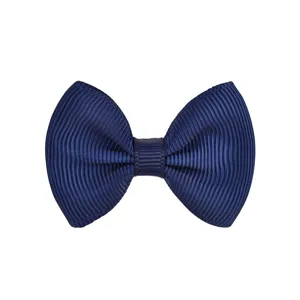 Macro view of a navy blue grosgrain ribbon bow hair clip for children and toddlers
