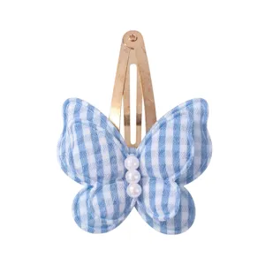 Detail view of blue plaid butterfly hair clip with pearl beads. Cute snap hair accessory.