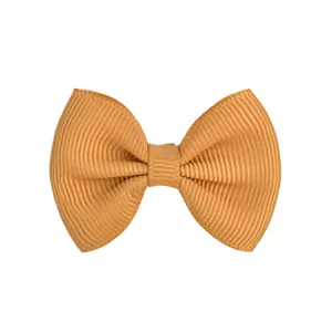 Close-up detail of a golden ribbed grosgrain ribbon bow hair clip for kids