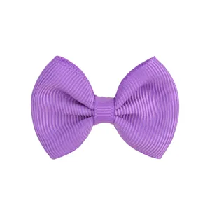 Detailed macro view showing the ribbed texture of a purple grosgrain bow hair clip