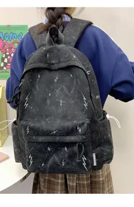 Back view of a stylish black student backpack featuring white lightning bolt patterns