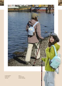 Women's outdoor color-block hiking backpack shown on models in scenic river setting.