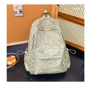 Close-up of a large green student backpack with lightning patterns in a cozy setting
