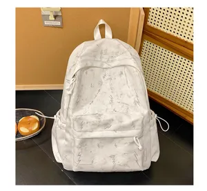 Detailed view of white marble patterned backpack with grey lightning bolt embroidery