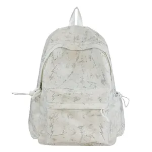 Detailed view of white schoolbag with marble texture and silver lightning bolt patterns