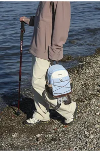 Outdoor lifestyle detail shot of a small color-block backpack for hiking and travel