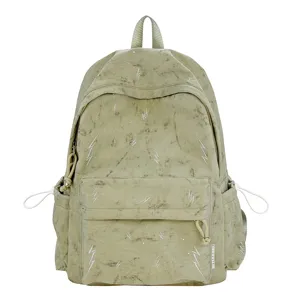 Detail view of the sage green schoolbag with a decorative white lightning bolt print pattern