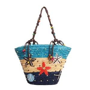 Handwoven multi-color straw tote bag with flower accents and beaded rope handles