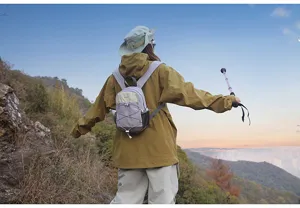 Detailed view of a small lavender hiking backpack worn in a mountain trekking scene