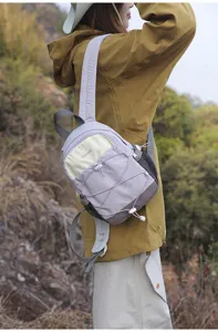Small lavender contrast color backpack worn outdoors for hiking and commuting.