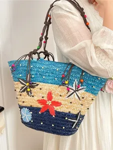 Large handmade woven straw tote bag with colorful flower patterns and beaded detail