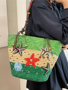 Large vibrant woven straw tote bag featuring colorful flower accents and bead straps